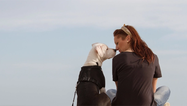 Woman and dog touching noses