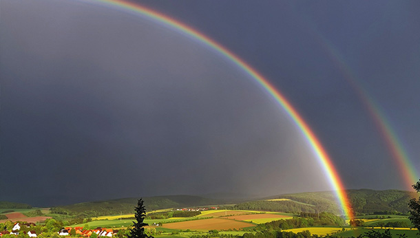rainbow over rolling fields